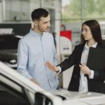 Woman Selling Car to Client in Salon