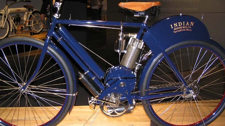 Antique blue Indian motorcycle displayed in a museum