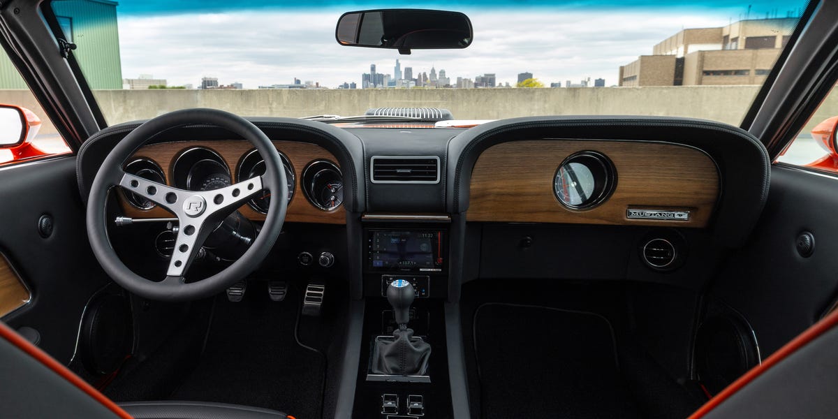 Interior view of Revology Mustang Boss 302 with wood dash and manual shifter