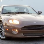 Aston Martin DB7 Vantage front three-quarter view with lights on