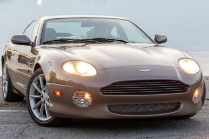 Aston Martin DB7 Vantage front three-quarter view with lights on