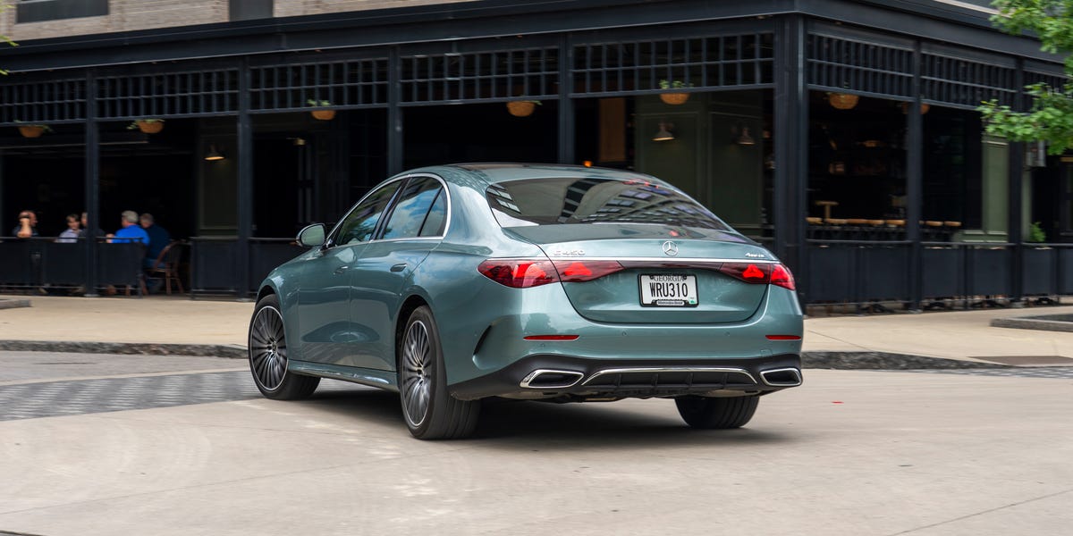 Rear three-quarter view of a teal Mercedes-Benz E450 sedan parked outdoors