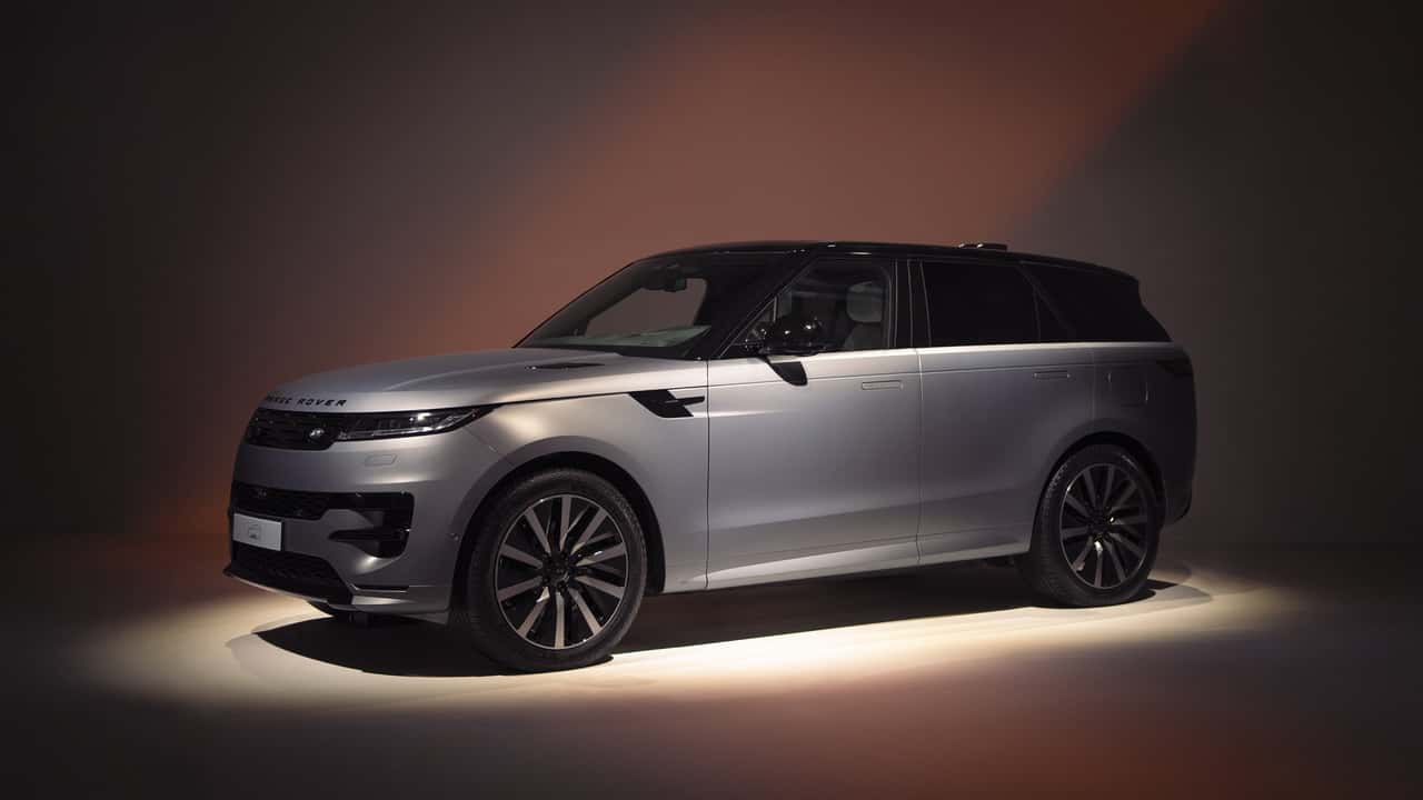 Silver Range Rover Sport SUV in dramatic studio lighting