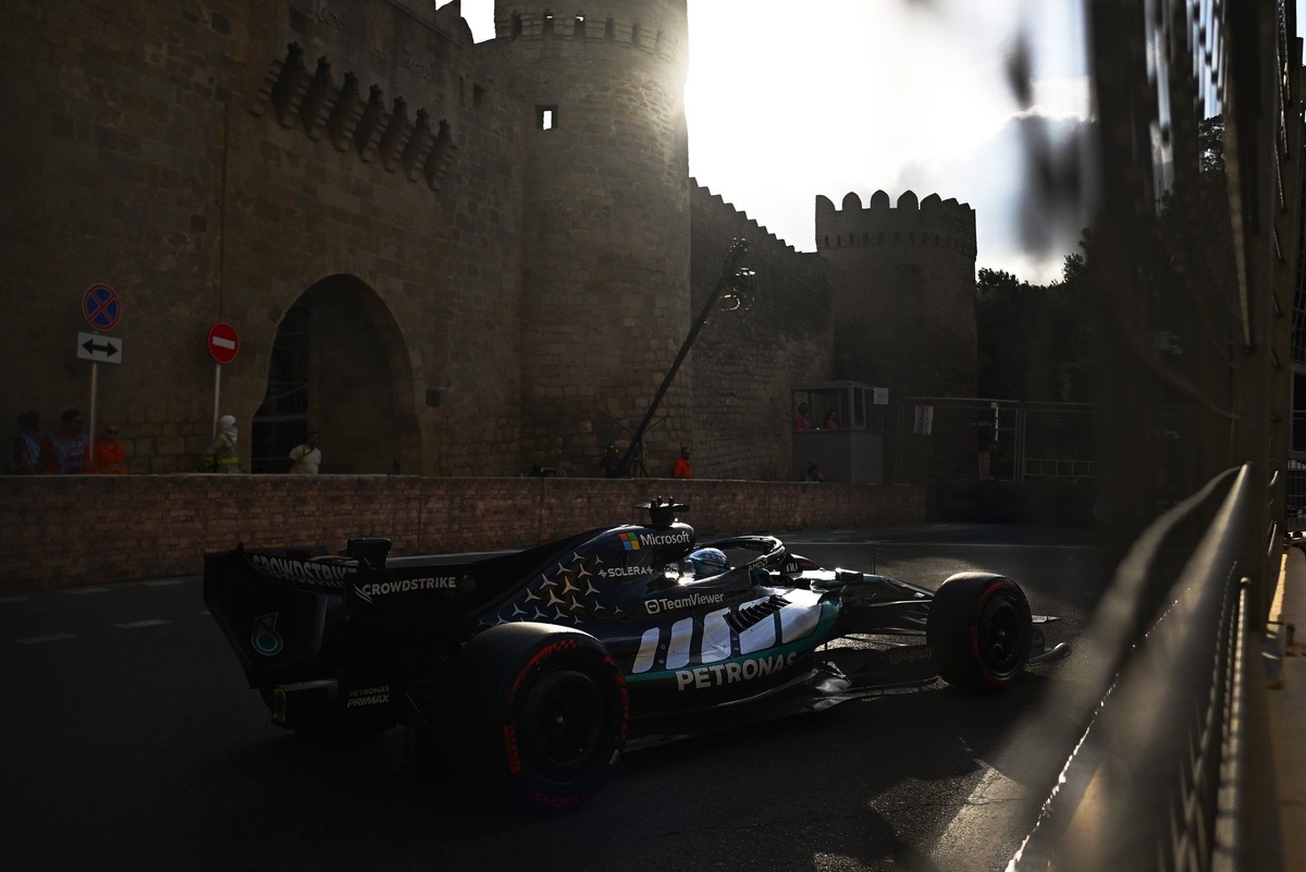 Mercedes F1 car passing Baku Old City wall on track