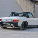 White Porsche 914 parked near gravel piles