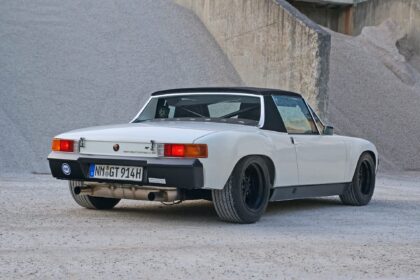 White Porsche 914 parked near gravel piles