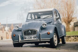 Classic light blue Citroën 2CV parked on a street Classic light blue Citroën 2CV parked on a street