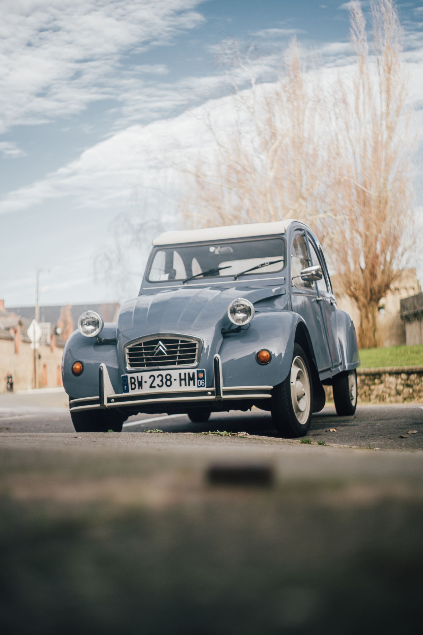 Classic light blue Citroën 2CV parked on a street