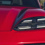 Close-up of a modern LED car headlight on a red vehicle
