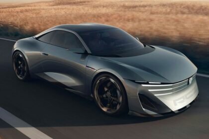 Silver Peugeot RCZ Vision sports car driving on a road Silver Peugeot RCZ Vision sports car driving on a road