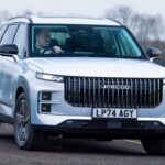 Silver Jaecoo 7 SUV driving on a country road