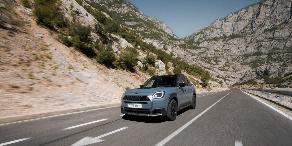 Blue Mini Countryman driving on a scenic mountain road