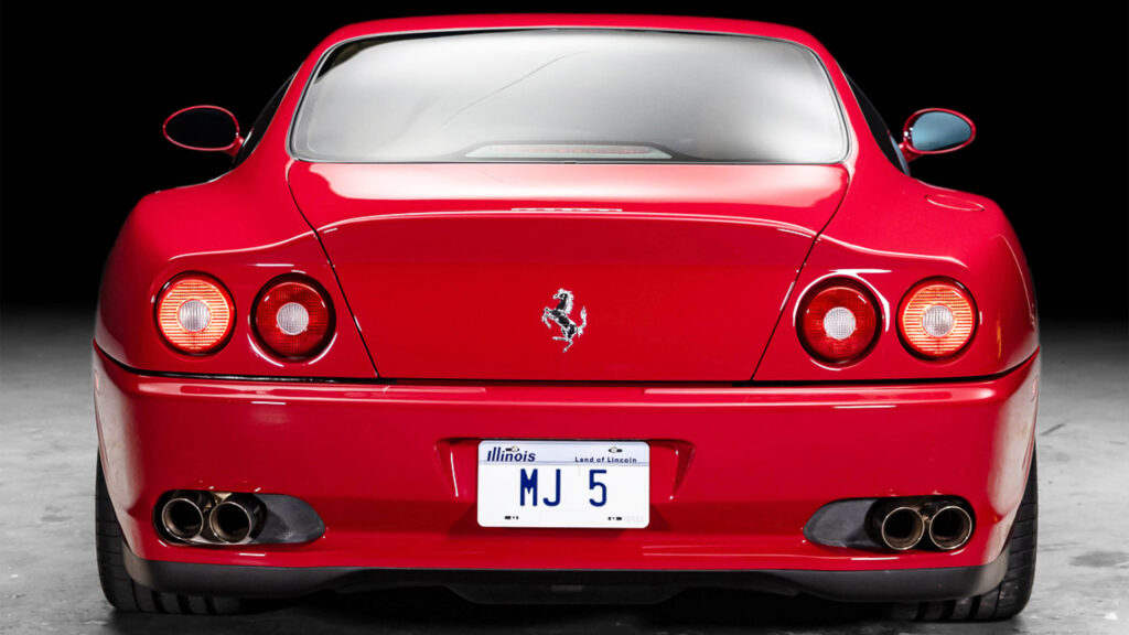Rear view of red Ferrari 550 Maranello with MJ 5 license plate