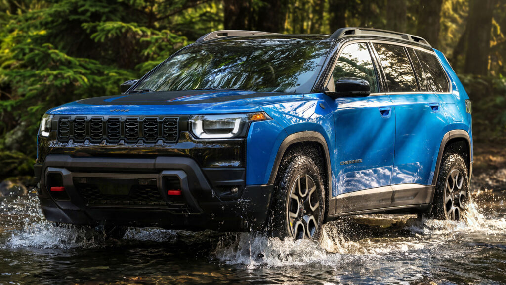 Blue Jeep Cherokee Trailhawk splashing through water on off-road trail