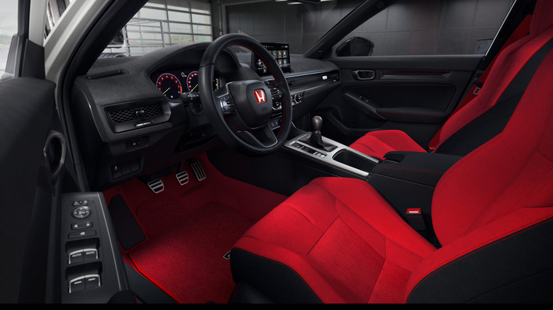 Interior view of Honda Civic Type R with red sport seats and manual shifter