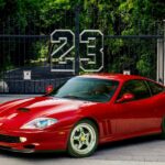 Red Ferrari 550 Maranello parked in driveway with 23 gate