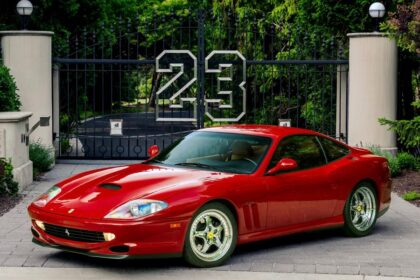 Red Ferrari 550 Maranello parked in driveway with 23 gate Red Ferrari 550 Maranello parked in driveway with 23 gate