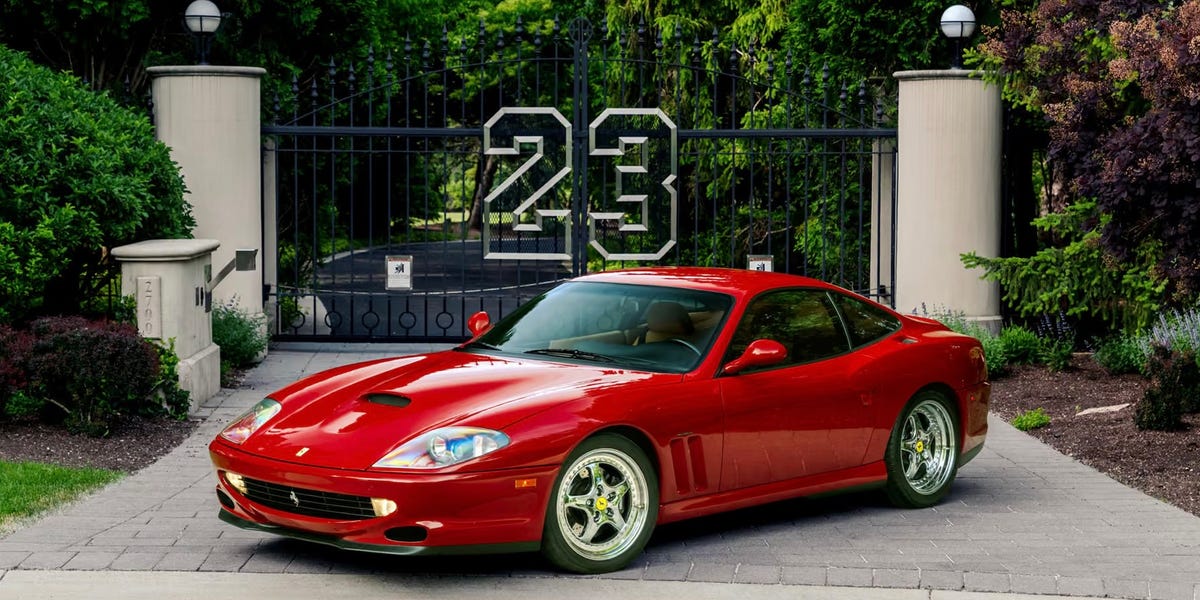 Red Ferrari 550 Maranello parked in driveway with 23 gate