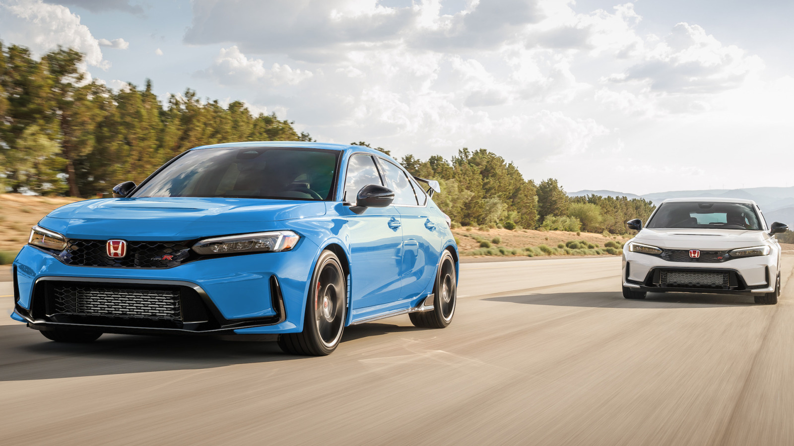 Blue and white Honda Civic Type R cars driving on a road